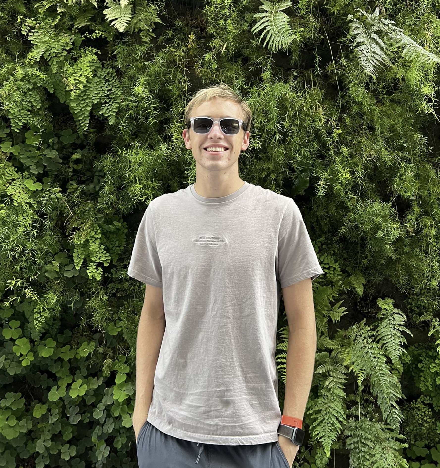 Matthew Van Dyke standing in front of a green background